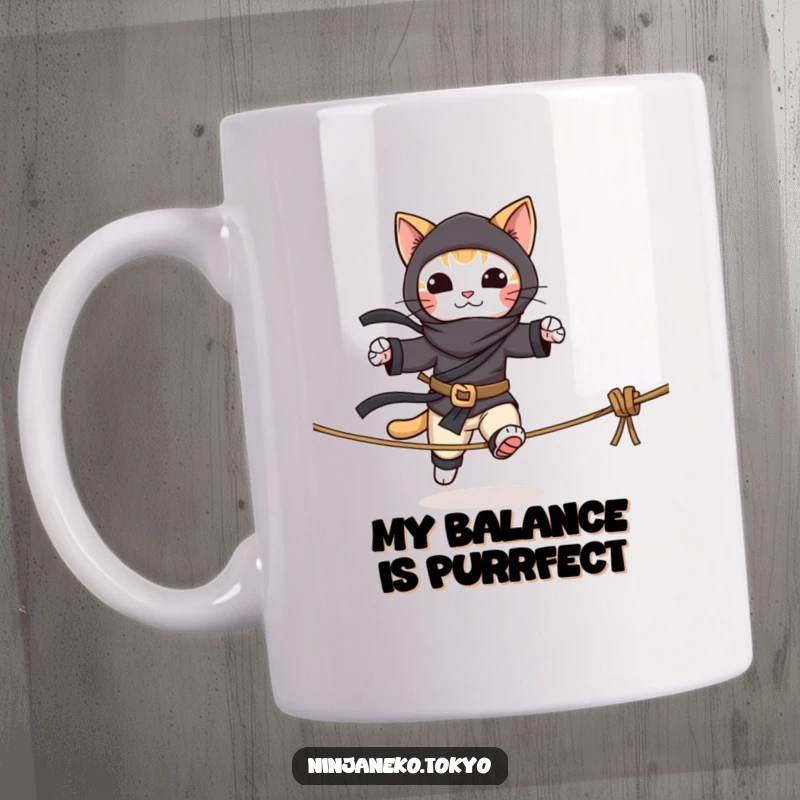 Funny mug featuring a playful cat dressed as a ninja, precariously balancing on a rope tightrope. A humorous scene of feline focus.