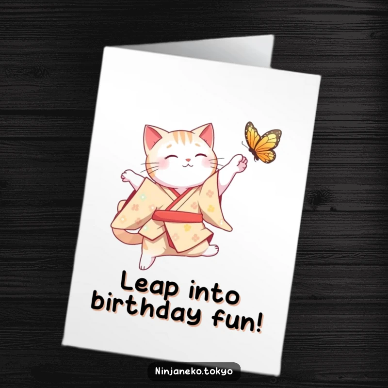 Funny Free Printable Birthday Card: A cute cat in a traditional kimono gracefully leaping to catch a fluttering butterfly.