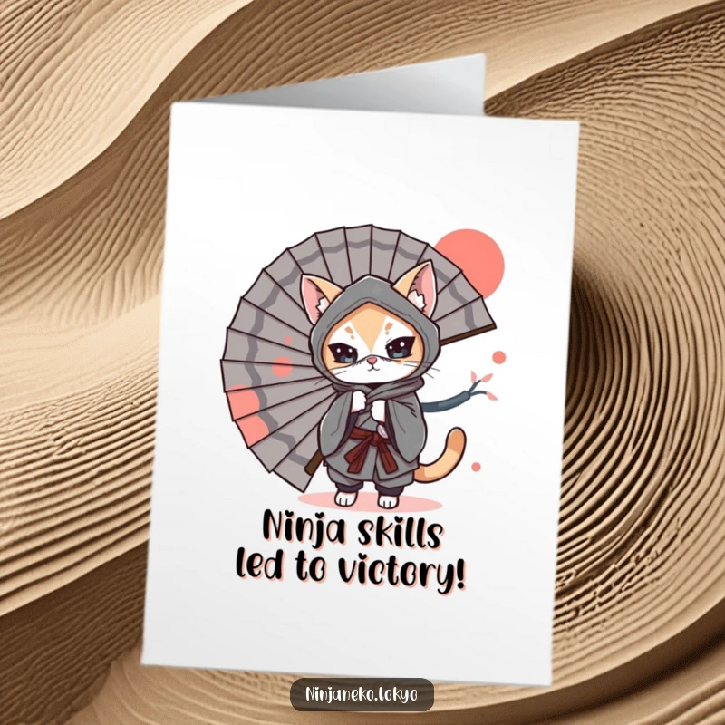 Funny Free Printable Congratulations Card: A ninja cat wearing a kimono playfully hides behind a large fan, ready to surprise.