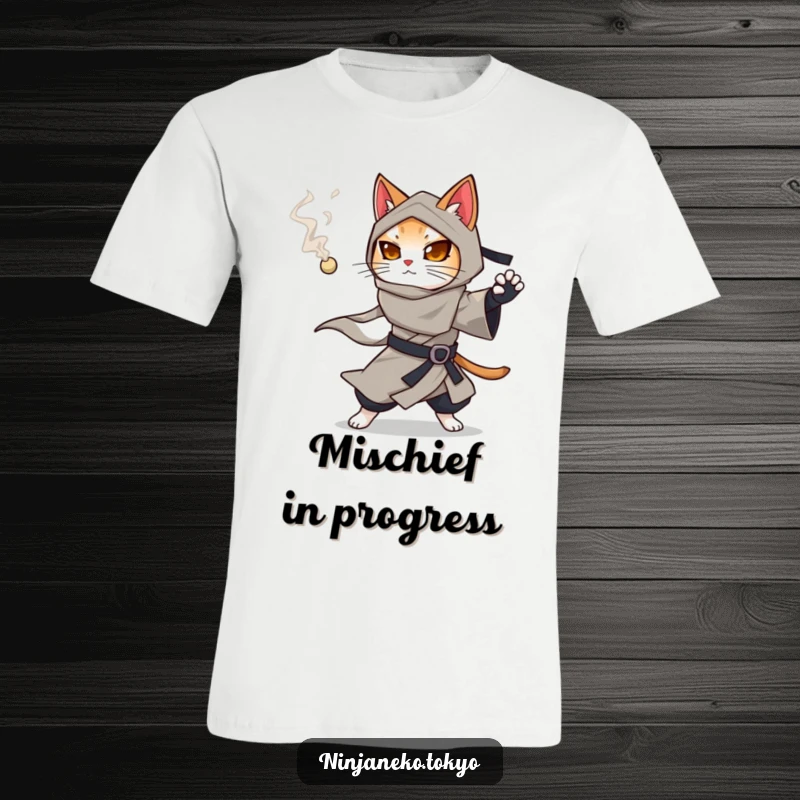 Funny ninja cat in a flowing kimono holding a smoking pellet, ready to deploy it on this humorous t-shirt.